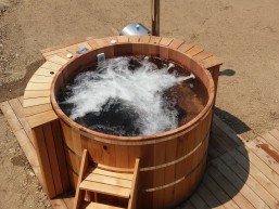 Red cedar hot tub stand alone on the deck with wood fired heater 