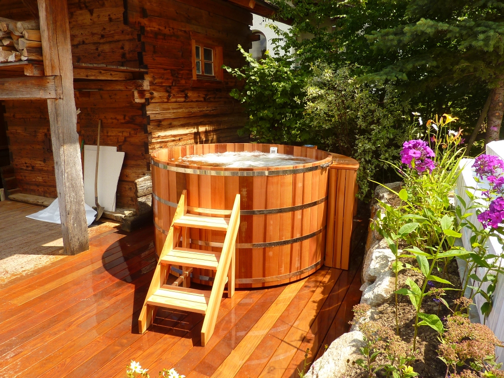 wooden hot tub stand alone on the deck 