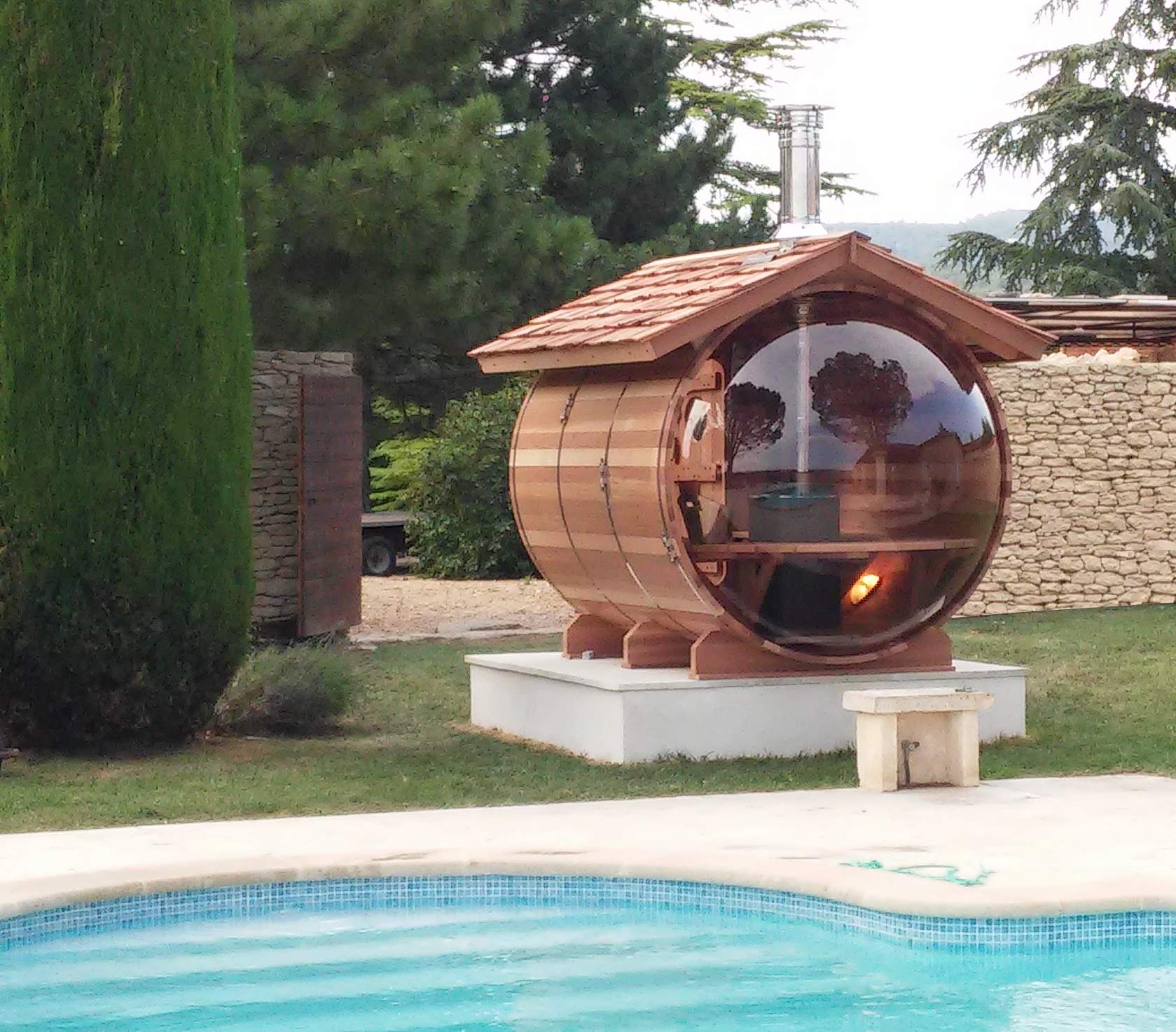 Wood-heated bubble sauna with a its roof covered with red cedar shingles